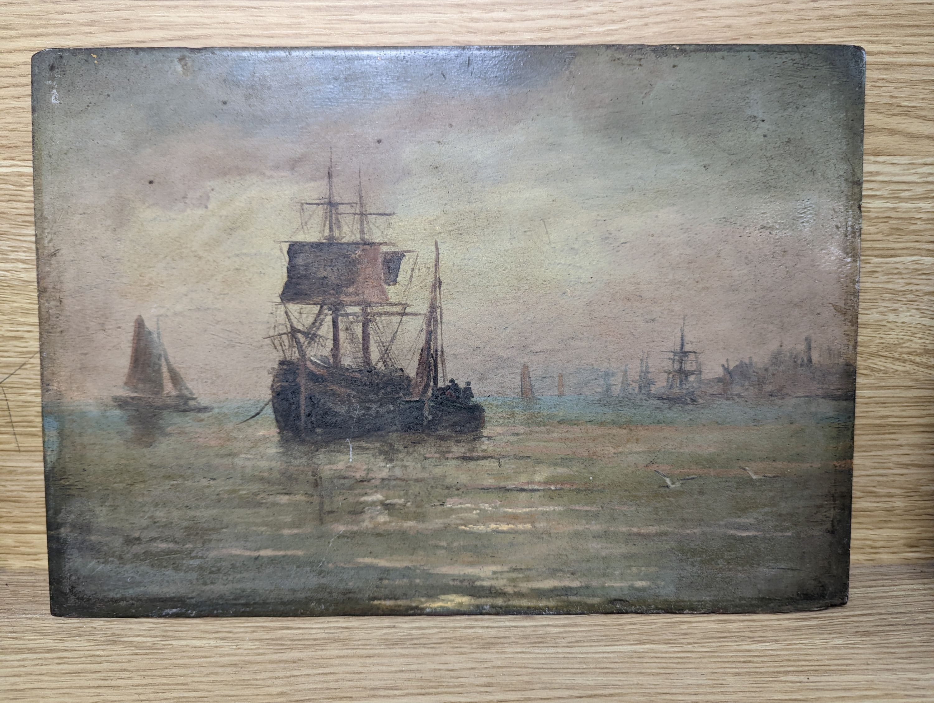 19th century English School, oil on mahogany panel, Shipping off the coast at sunset, 25 x 36cm, unframed